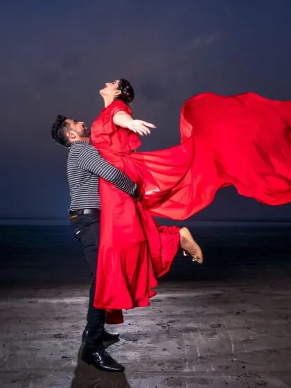 Feel the romance with this powerful pre-wedding shot. The red flying gown creates a sense of freedom and passion, making for a truly memorable photograph.