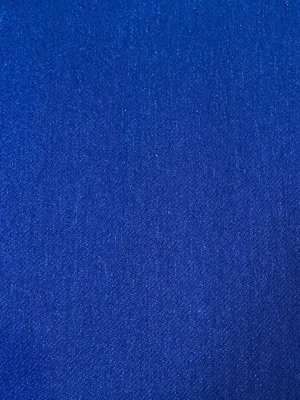 A close-up of a vibrant royal blue denim fabric. This is a great choice if you want to make a bold statement with your custom jeans.