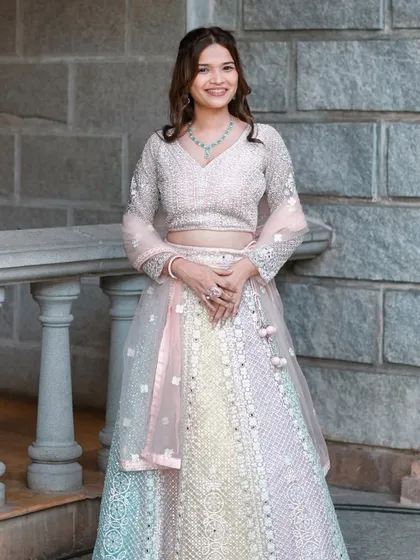 Bridesmaid glam in a stunning multi-colored pastel lehenga. The makeup is soft and pretty, complementing the outfit perfectly.