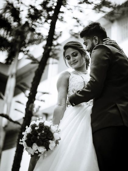 A classic black and white portrait of a Christian bride and groom. This low-angle shot adds a touch of drama and romance, highlighting the couple's connection.