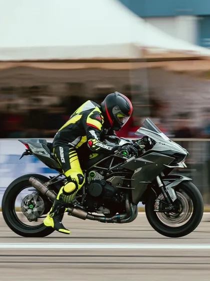 The unmistakable silhouette of a Kawasaki Ninja H2 at full throttle. The supercharged engine makes this one of the fastest bikes on the strip.