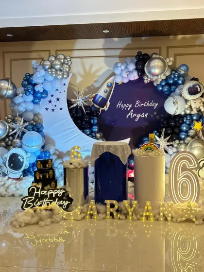 For the little astronaut, this outer space theme is a blast! I created a complete galaxy experience with a crescent moon backdrop, planet and rocket balloons, astronaut cutouts, and cloud-like floor decor to make Aryan's 6th birthday truly out of this world.
