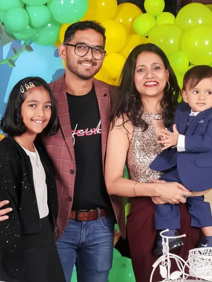 A lovely portrait of the birthday boy with his parents and older sister, capturing the complete family on this special day.