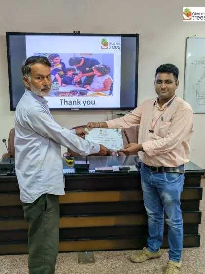 Awarding a certificate to a participant of our horticulture workshop. We believe in recognizing and encouraging every individual's effort to learn and grow.