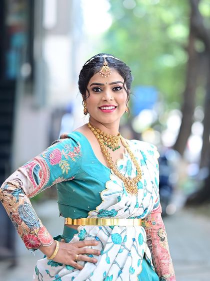 A portrait of Preethi, showing off her beautiful smile and the details of her makeup and hairstyle.