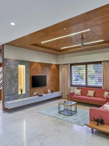This living room combines warm wood ceilings with soft, comfortable furnishings. I designed the space to feel open yet cozy, with a custom media wall that is both functional and a beautiful focal point.