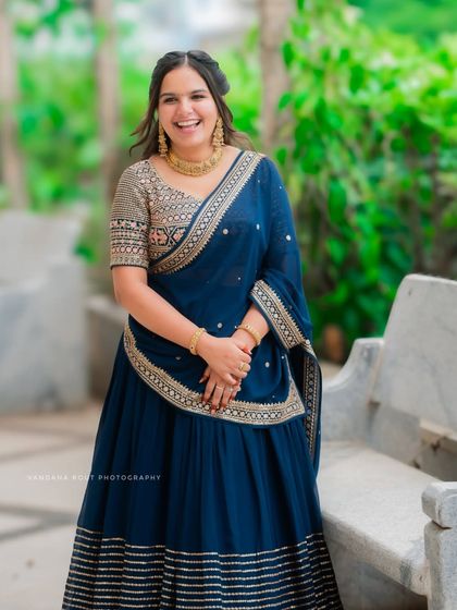 A beautiful solo portrait of the bride-to-be, showcasing her radiant smile and elegant blue lehenga. I always make sure to capture individual portraits that highlight the joy of the occasion.