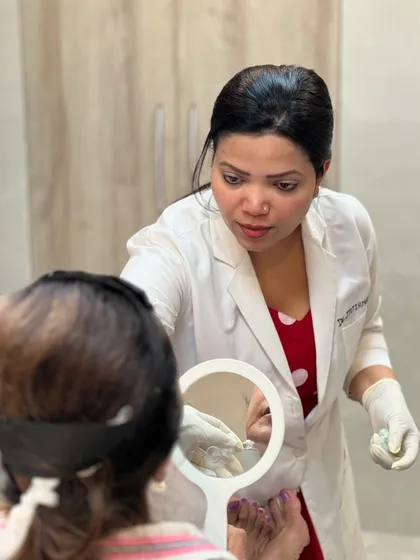 A close-up of the consultation process for fillers. Using a mirror, I help the client visualize how adding subtle volume can lift and support the facial structure for a natural-looking enhancement.
