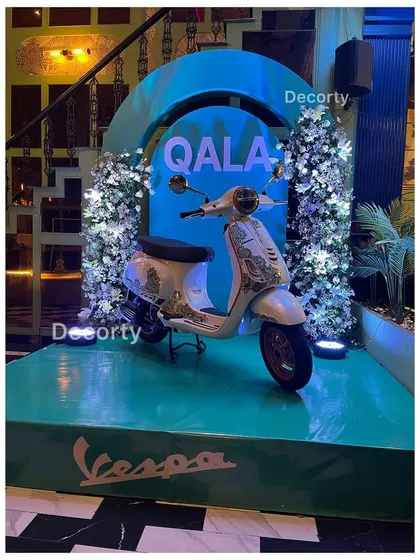 For the launch of Vespa's 'Qala' edition, I created a stunning display stage that put the product front and center. This setup combines elegant floral work with bold, illuminated branding to create a high-impact brand activation.