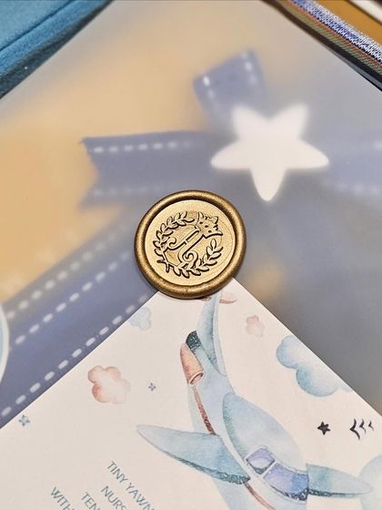 A close-up of a custom wax seal with the baby's initial. This is one of the small but significant details that makes my book box creations so beloved by my clients.