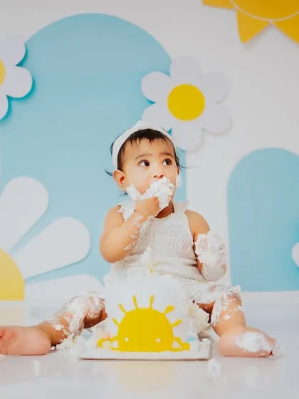 A moment of sweet contemplation before the next handful of cake. These sessions are full of different expressions, from excitement to curiosity.