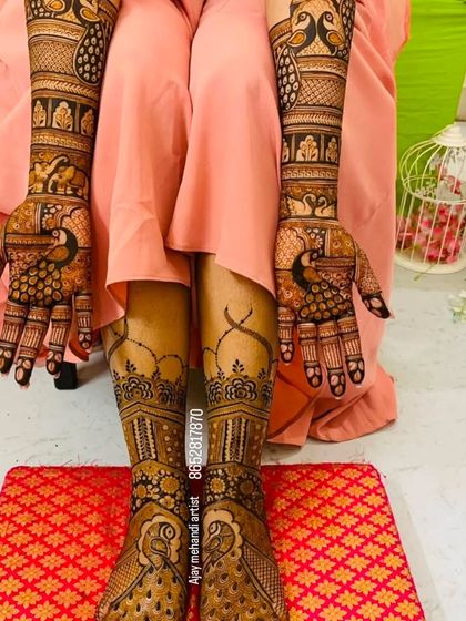 This photo showcases a complete bridal set with matching peacock designs on the hands and feet, perfect for a traditional and graceful look.