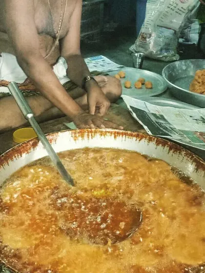 The art of making traditional sweets in large quantities requires immense skill. Here, our expert chef is preparing a sweet dish in a large kadai, a common sight in our kitchen during festival seasons and for large wedding orders.