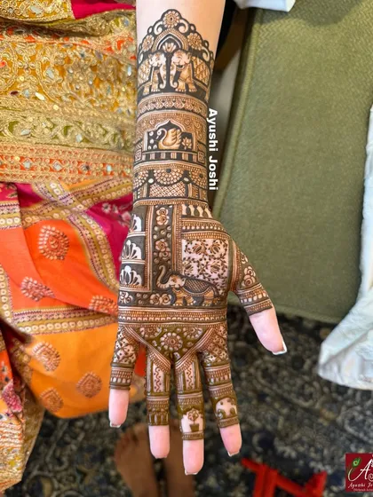 A side view of the short-length bridal design, focusing on the details of the patterns on one hand.
