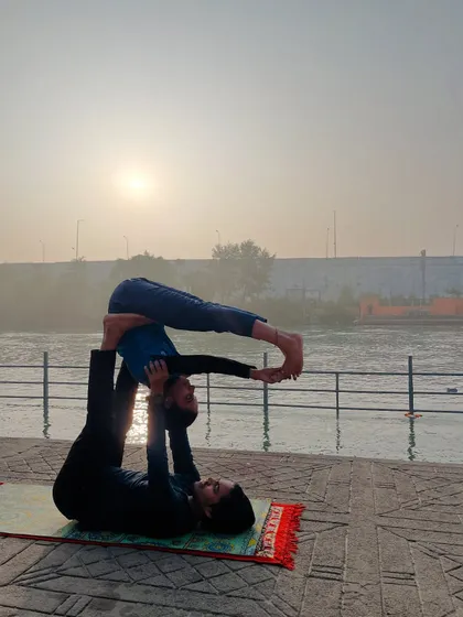 A deeper variation of the folded leaf, where the flyer holds their feet for an intense hamstring stretch.