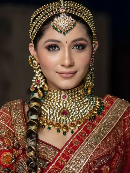 A captivating portrait of a bride exuding royal charm. The combination of the elaborate headpiece and the perfectly executed makeup creates a truly unforgettable look.