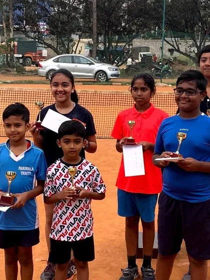 Celebrating the success of our young players at a local tournament. It's a proud moment to see their hard work pay off with trophies and certificates. This is what our youth tennis match-play training prepares them for.