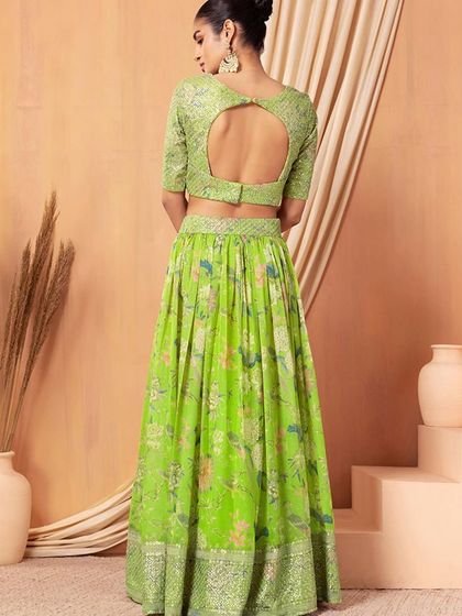 This neon green lehenga is pure energy. The floral organza skirt paired with a sequined blouse makes it a fresh and modern choice for any function.