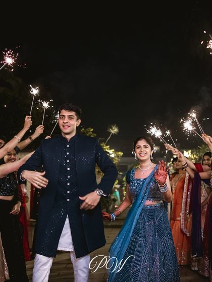Another joyful sparkler entrance, capturing the couple's excitement as they join their friends and family for a night of dancing and celebration.