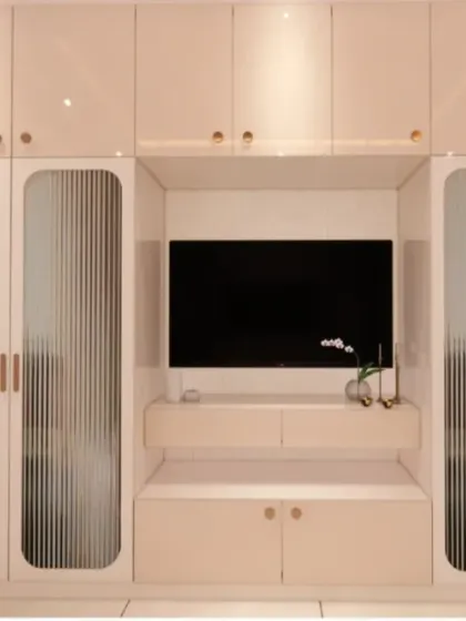 A render of a bedroom TV unit integrated within a large wardrobe, a great space-saving solution for modern bedrooms.