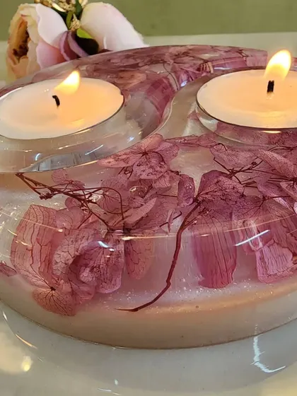 A close-up of the pink floral tealight holder, showing the intricate details of the preserved flowers.