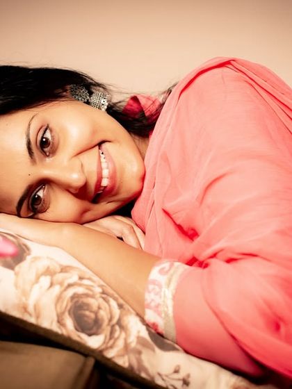 A sweet and joyful expression. This relaxed, lying-down pose creates an intimate and friendly portrait.