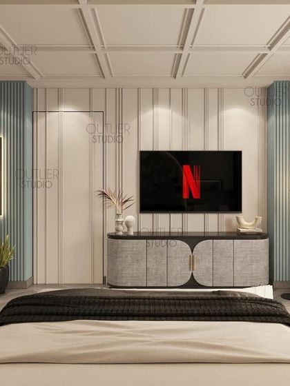 Calling all Netflix enthusiasts. This bedroom features a cool blue and white color palette, with a media wall that is both simple and stylish, perfect for a modern, relaxed vibe.