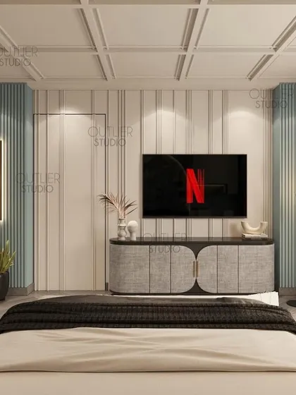 Calling all Netflix enthusiasts. This bedroom features a cool blue and white color palette, with a media wall that is both simple and stylish, perfect for a modern, relaxed vibe.