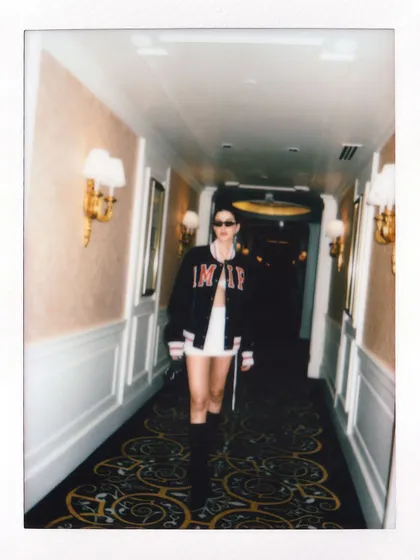 A candid polaroid of Shanaya Kapoor walking down the hallway, fully in character for her modern street-style look.