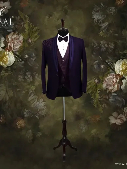 This purple Italian suit is for the groom with a flair for the dramatic. The design features a floral patterned vest and subtle self-color embellishments on the shoulder, offering a look that is both regal and contemporary.