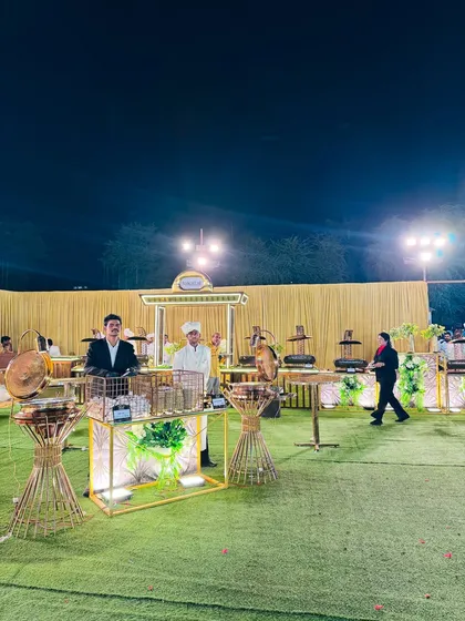 The chaat and other food stations at night, well-lit and inviting for guests.