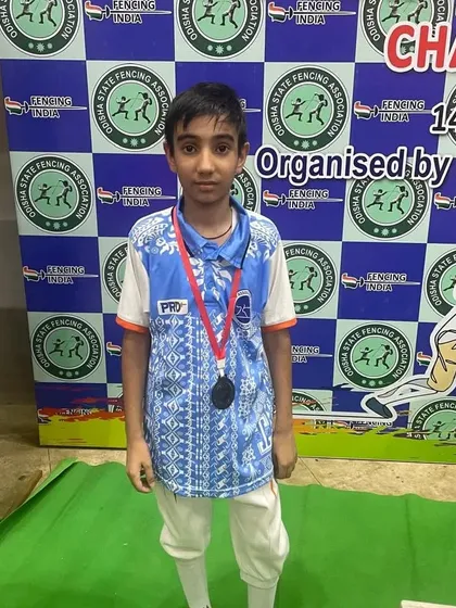 One of our youngest competitors stands with his medal at a national championship. We nurture talent from a very early age, providing a strong foundation for a competitive career.