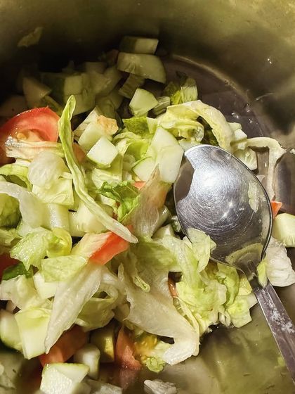 A simple green salad with lettuce, cucumber, and tomato. A great way to add fiber and freshness to any meal.