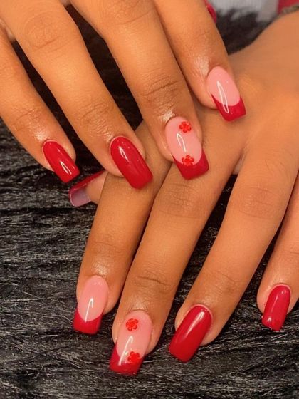 A full view of the red French manicure with 3D flower charms.
