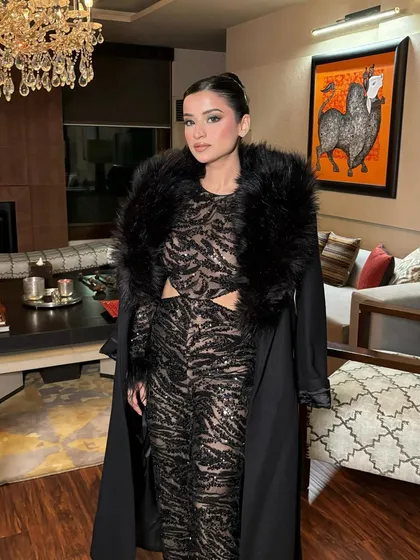 The winter party look is complete with a chic faux fur-collared coat. The glamorous makeup holds its own and completes the ensemble.