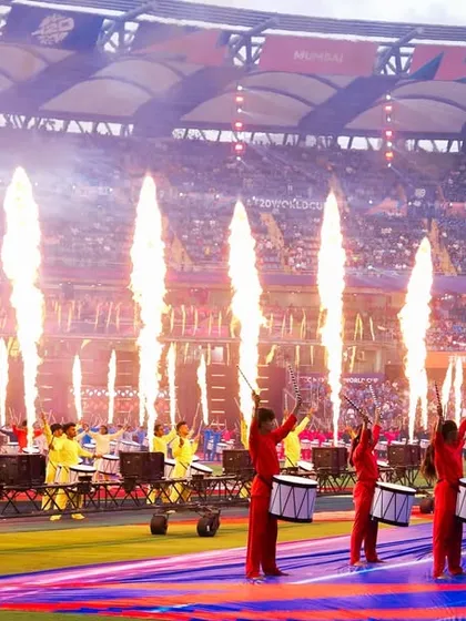 The power of a live performance is in the details. Here, a synchronized drum line is amplified by perfectly timed pyrotechnics during the ICC Men's T20 World Cup opening ceremony, creating a high-energy spectacle.