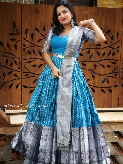 This blue and silver Anarkali-style gown is a beautiful example of my Indo-Western collection. It combines traditional motifs with a modern silhouette, making it a versatile rental for various festive occasions.