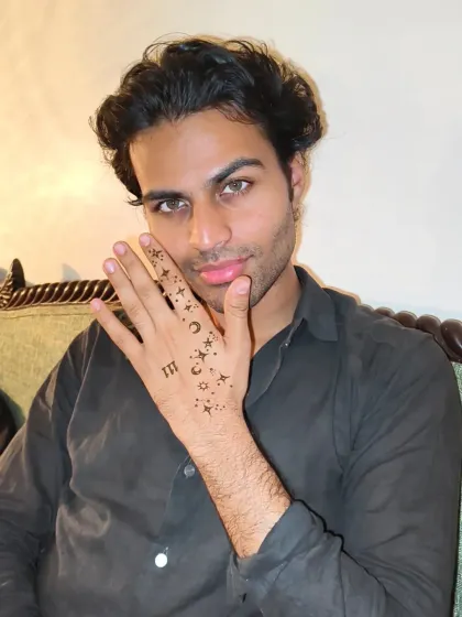 A male model showing off his celestial-themed henna. It's all about the attitude.