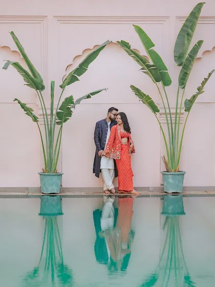 A quiet moment of connection against the grand architecture of a palace. This pre-wedding portrait captures a modern romance with a touch of timeless, editorial elegance by the water.