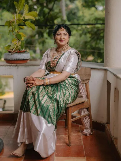 An elegant green and silver Kanchivaram saree paired with a silver brocade blouse. This is a sophisticated choice for a wedding reception or formal event.