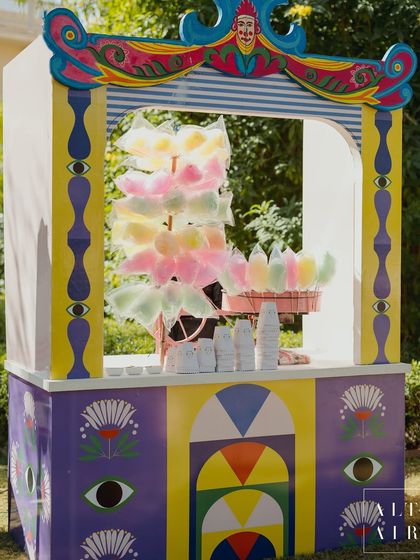 A whimsical, hand-painted cotton candy stall from 'The Roots' Mehendi. Every detail was a quiet statement, blending traditional motifs with a bold, contemporary art style.