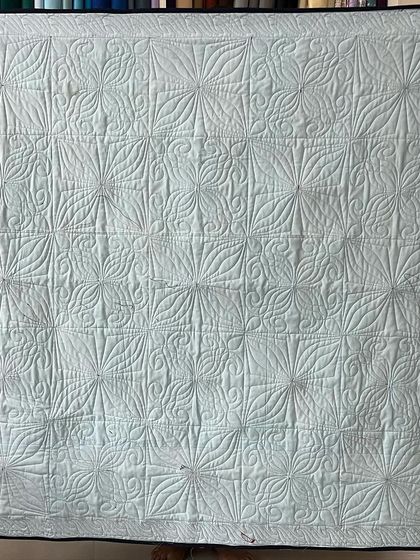 The back of the 4-patch quilt, showing the intricate quilting pattern.