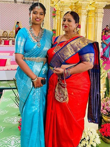 The joy of celebrating together is evident in this photo. Both women look stunning in their chosen sarees from our collection.