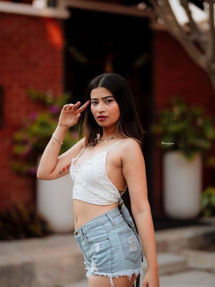 This image captures a classic street style pose against a colorful background. It's a great example of a straightforward but effective urban fashion shot.