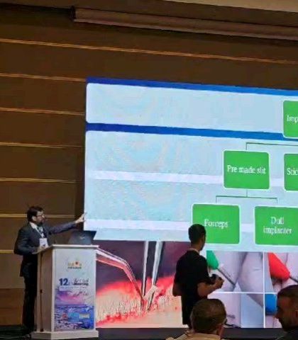 Presenting a flowchart on graft implantation techniques at the 1st FUE Global Meeting in Cyprus. The choice between forceps and implanters is a key decision.