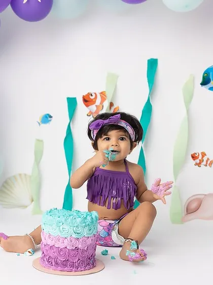 A wider view of the magical mermaid cake smash setup. I provide everything from the backdrop and balloons to the props to make your child's birthday theme come to life.
