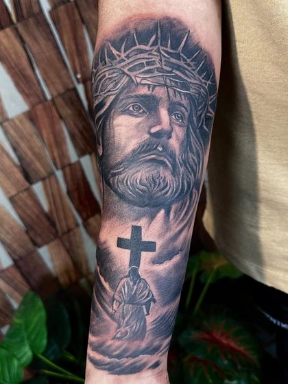 The final, healed look of the Jesus forearm tattoo. The shading has settled perfectly into the skin, creating a smooth and powerful image that will last a lifetime.