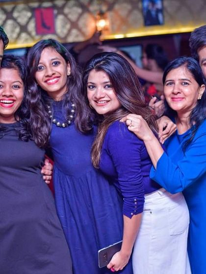 A group of friends smiling for the camera. My Bollywood nights are perfect for letting loose and dancing with your crew.