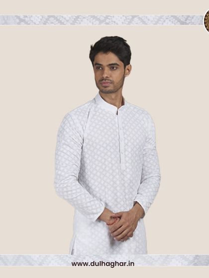 A model in a white patterned kurta, showcasing its clean and sophisticated look.
