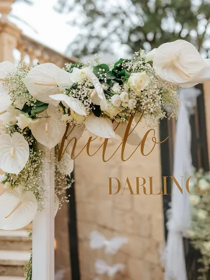 "Hello Darling." A sweet message on a welcome mirror, adorned with elegant white anthuriums and baby's breath. It's the little touches that speak volumes.